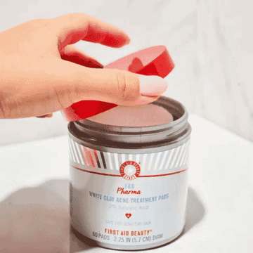 A GIF of someone opening the container of acne-clearing pads