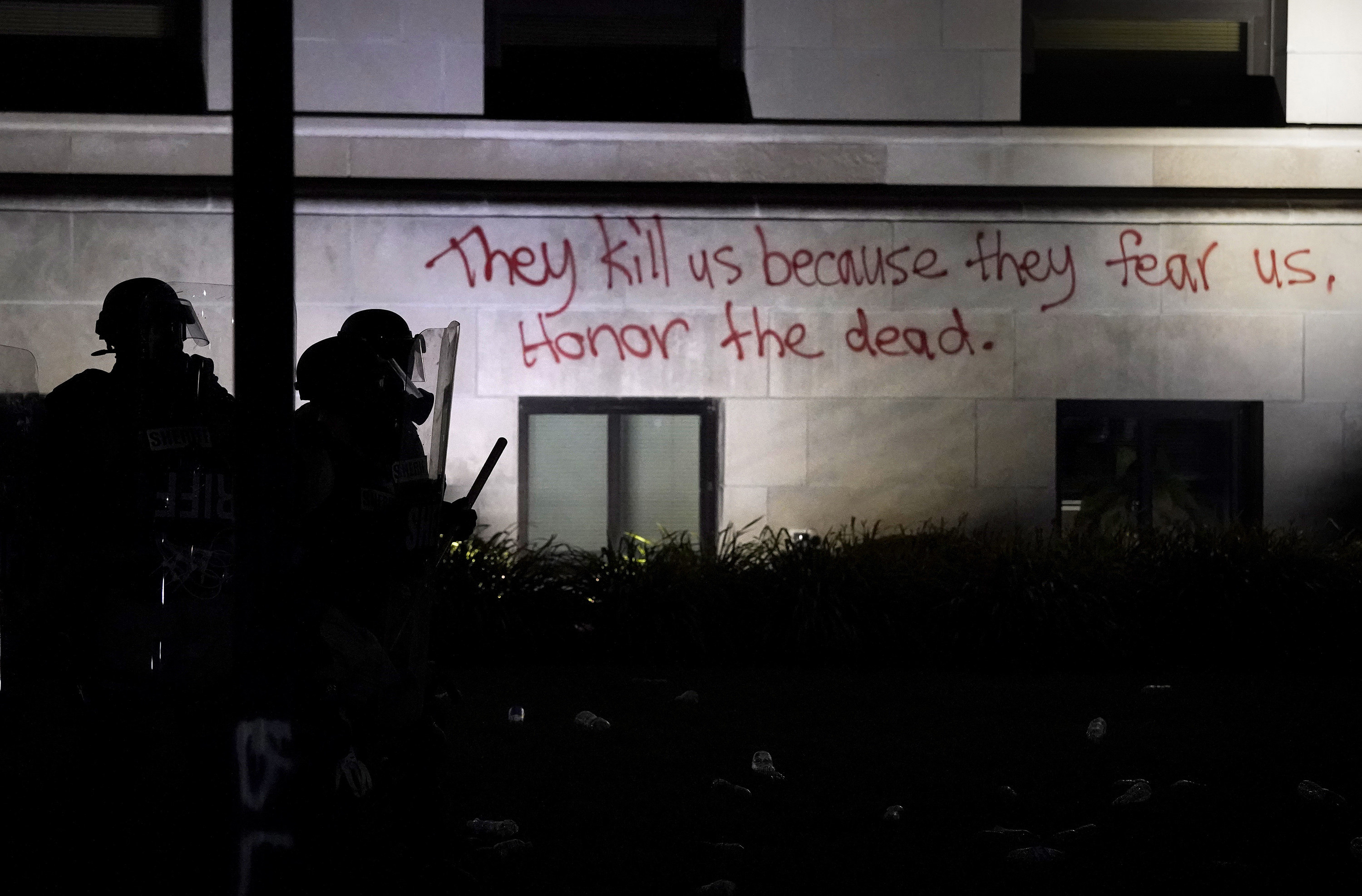 Spraypaint on the outside wall of the courthouse reads, &quot;They kill us because they fear us. Honor the dead.&quot;