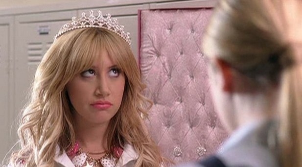 Sharpay rolling her eyes while wearing a tiara in the hallway