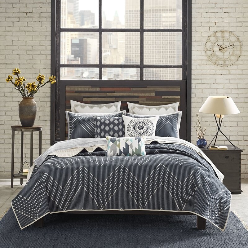 AllModern&#x27;s Mercado coverlet set in a navy blue with a white chevron stitching