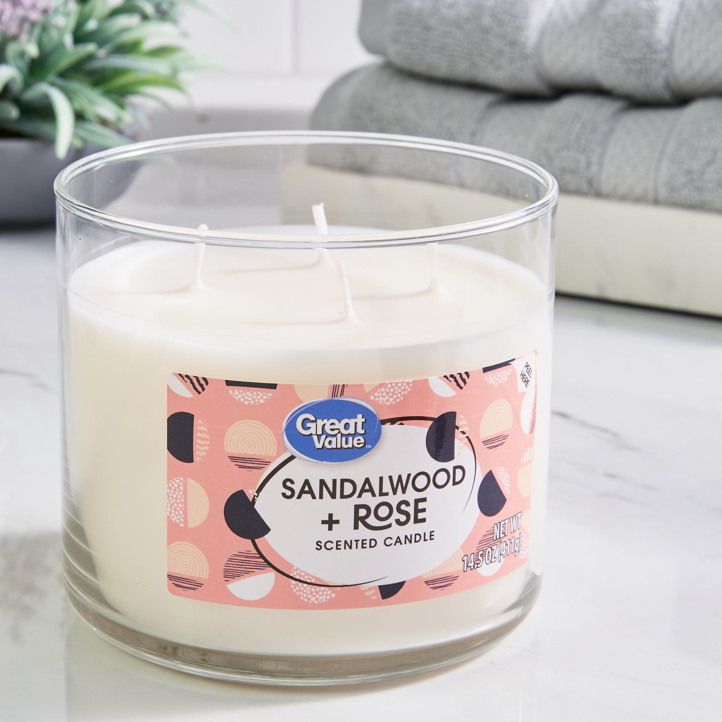 A sandalwood- and rose-scented candle with four wicks