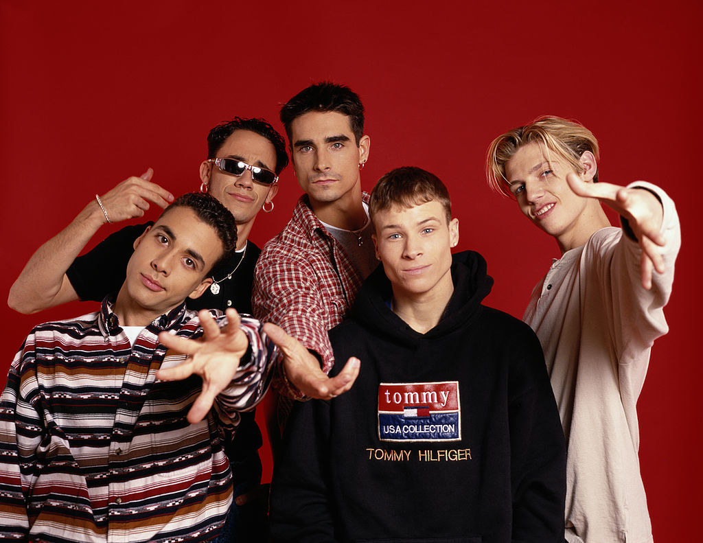 Photo of the Backstreet Boys up against a red background in the mid-&#x27;90s
