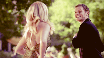 Klaus holding the application away from her as she tries to grab it