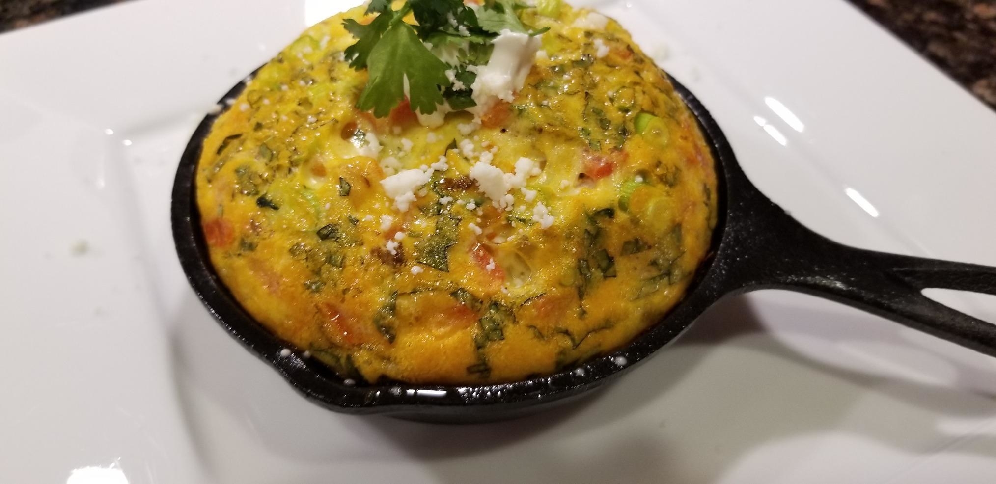 Reviewer using the skillet to make a fritatta