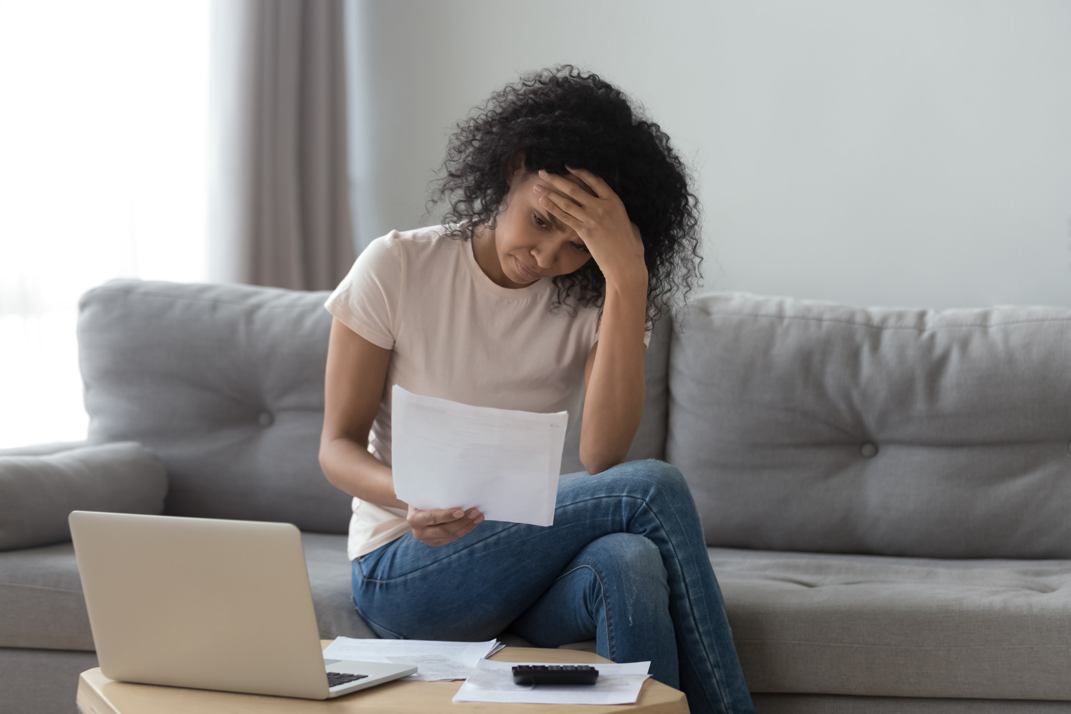 Stressed woman reading a piece of paper