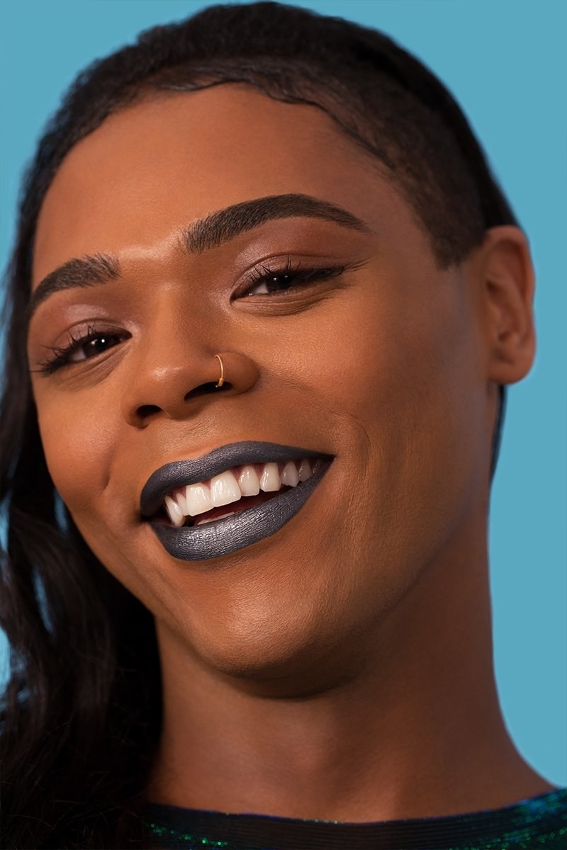 a model smiling and wearing the liquid lip 