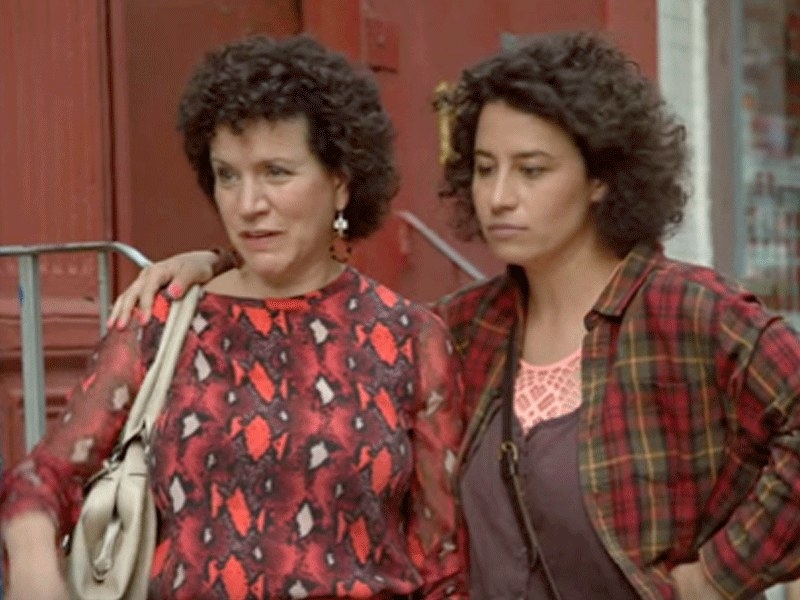 Ilana standing next to Bobbi with her arm over her shoulders in &quot;Broad City.&quot;
