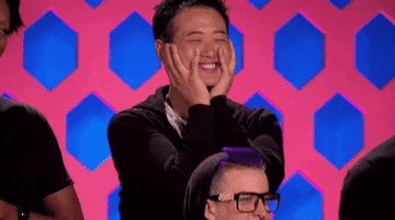A contestant from RuPaul&#x27;s Drag Race looking excited, with his hands on his face
