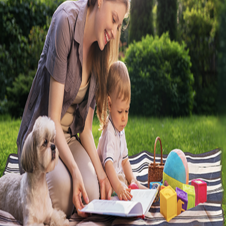 Parent and child and dog on the blanket 