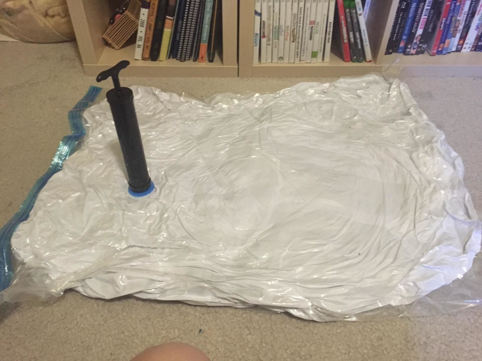 Amazon reviewer showing the hand pump sticking out of a flat jumbo storage bag