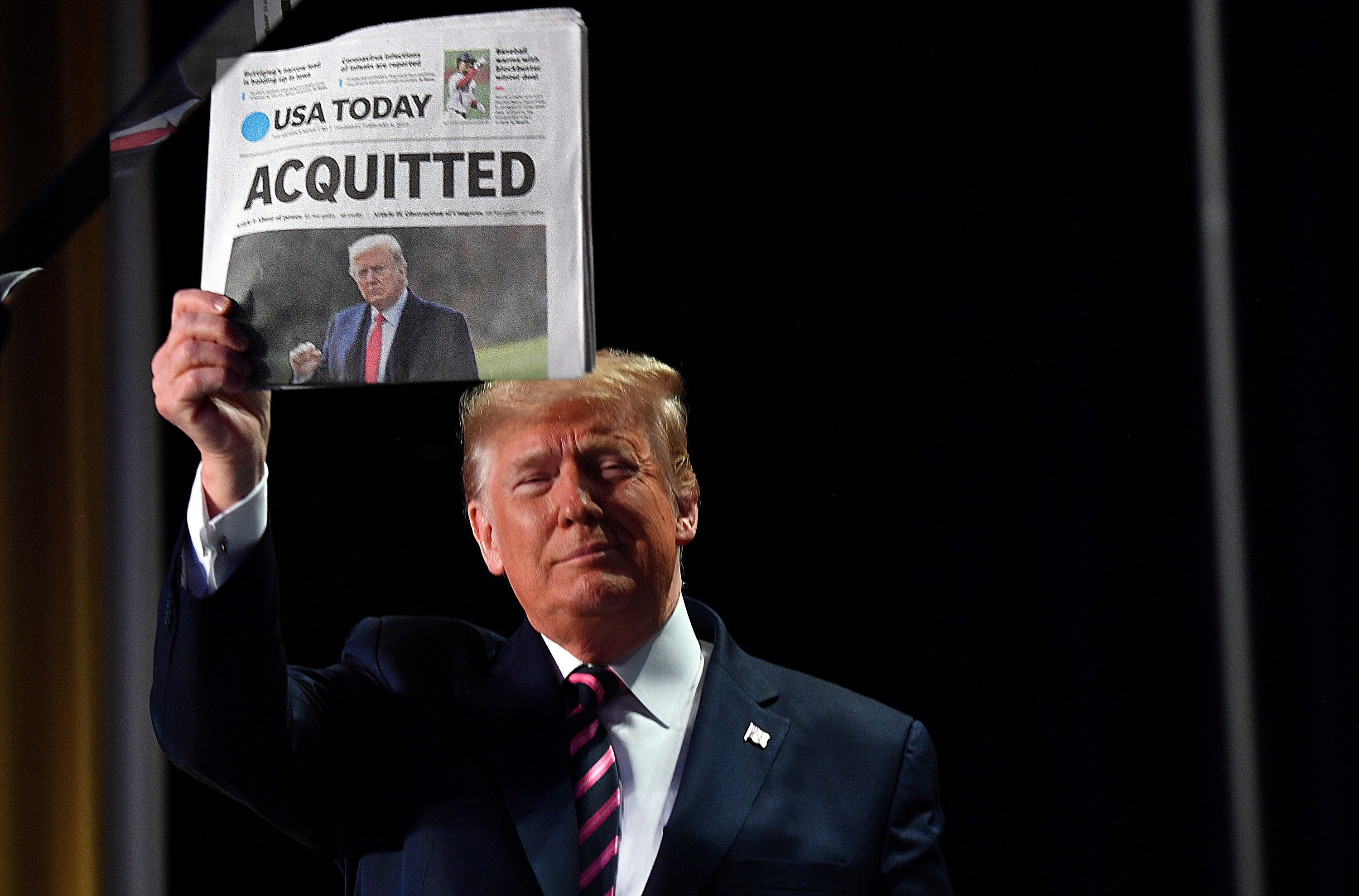 Trump holding USA Today with the headline &quot;Acquitted&quot;