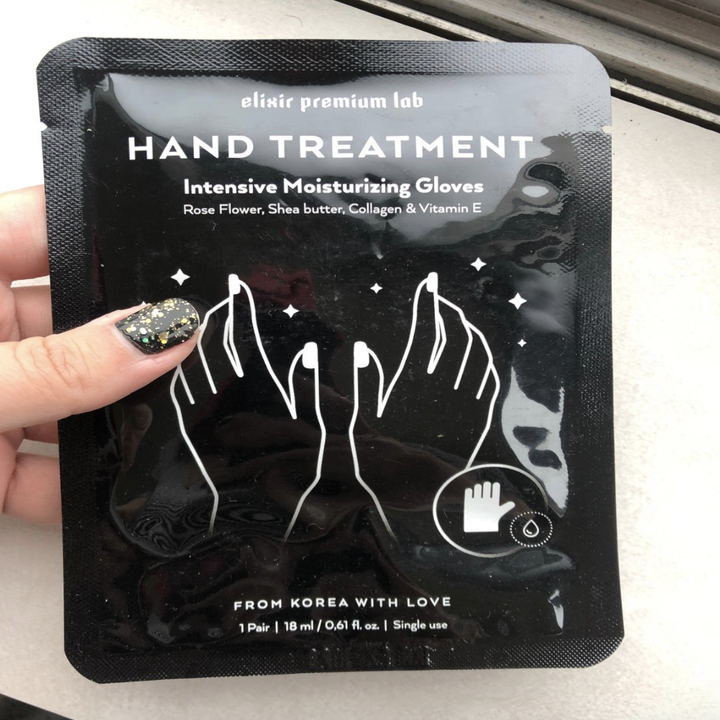 Reviewer holds black packaging that says "hand treatment" 