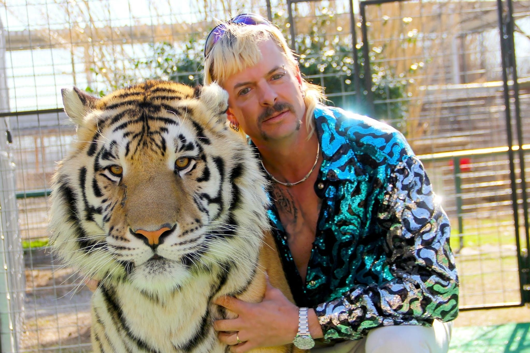 The Tiger King posing with a tiger