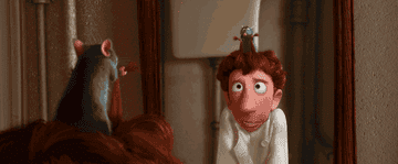 Gif of Remy from Ratatouille controlling Linguine&#x27;s shoulders