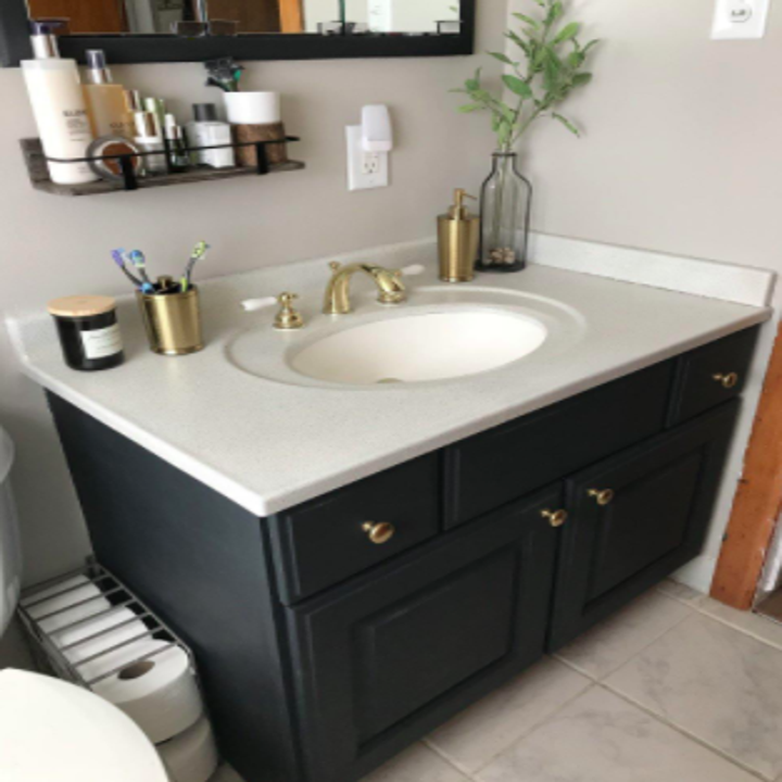 reviewer pic of transformed bathroom vanity with the help of the spray paint
