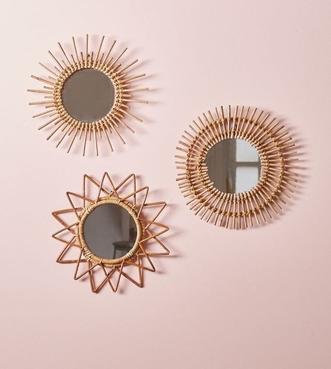 Three round mirrors with sunburst patterns woven on rims