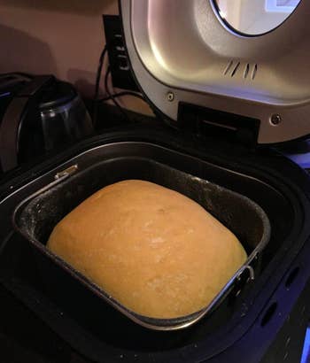 A reviewer photos of a loaf of bread that just baked inside of the bread maker