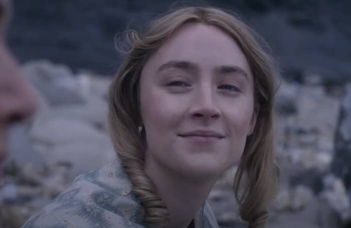 Saoirse Ronan looking wistfully at Kate Winslet on the beach