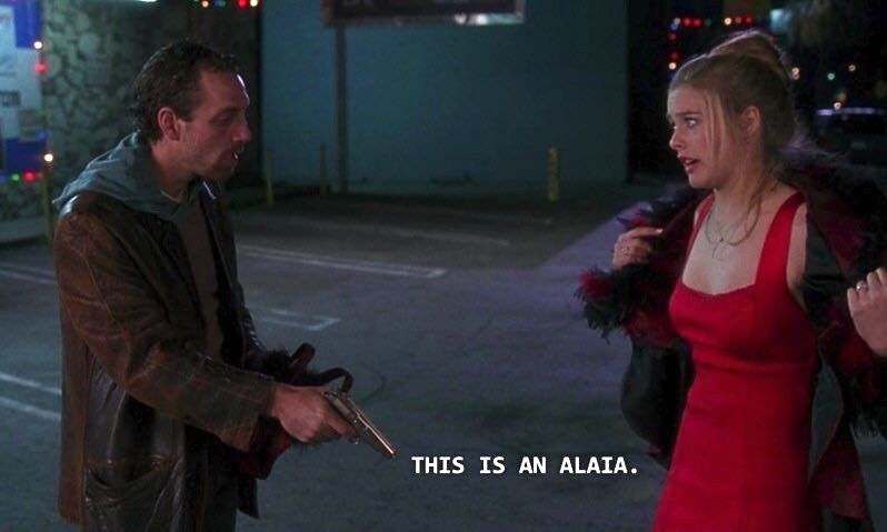 A screenshot of from &quot;Clueless&quot; of the scene where Cher is being mugged while wearing a red dress and says &quot;This is an Alaïa&quot;