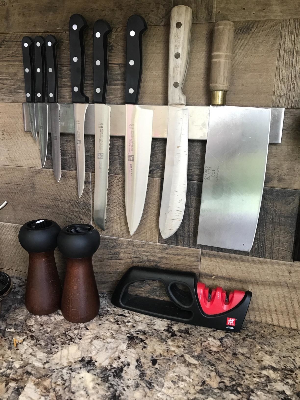Reviewer&#x27;s photo of knife magnet attached to kitchen wall
