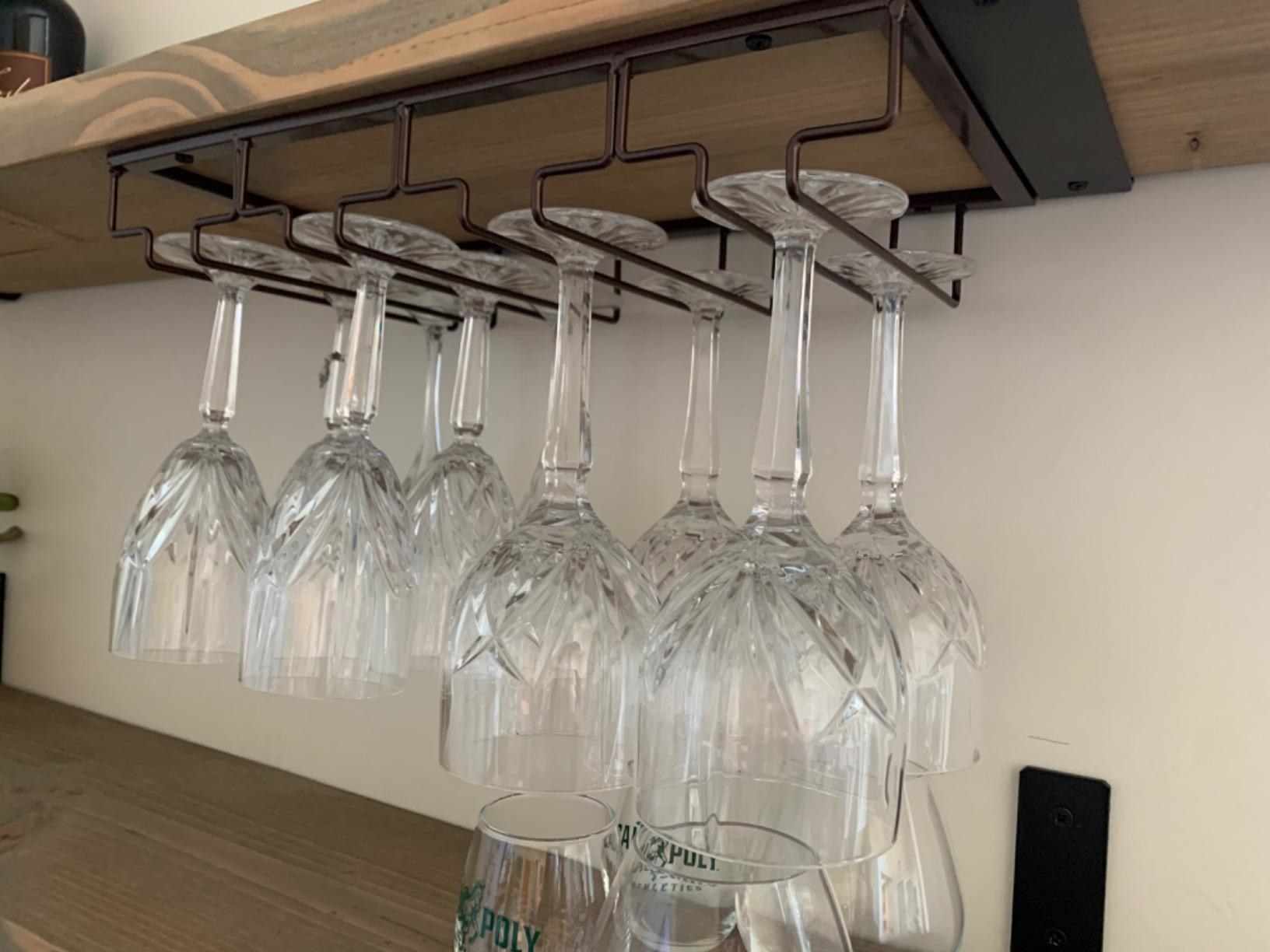Metal wire frame holding upside wine glasses