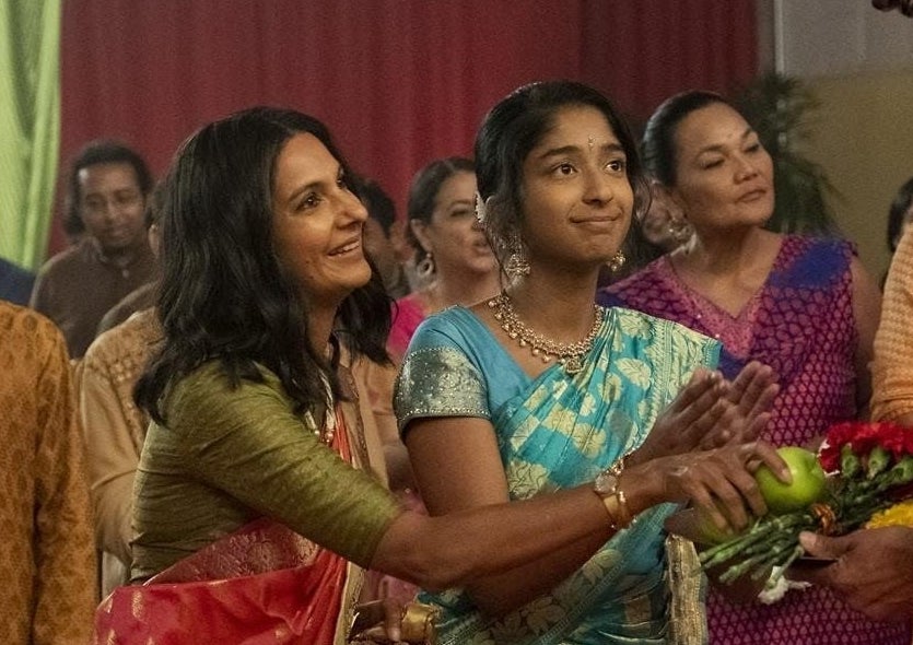 Devi and Nalini greeting their priest on &quot;Never Have I Ever.&quot; 