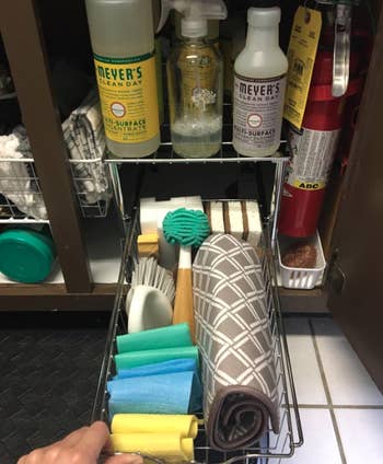 Another reviewer pulls out their drawer to reveal sponges, magic erasers, scrub brushes, etc.