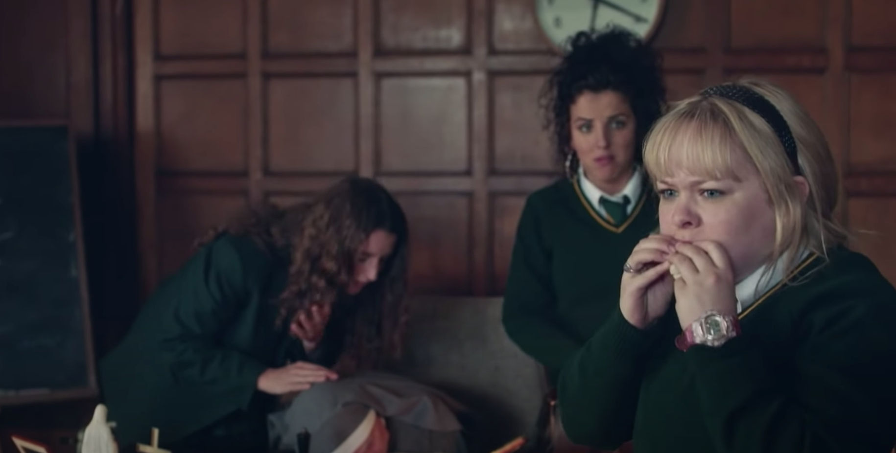 Michelle, Orla, and Clare in a classroom in &quot;Derry Girls.&quot;