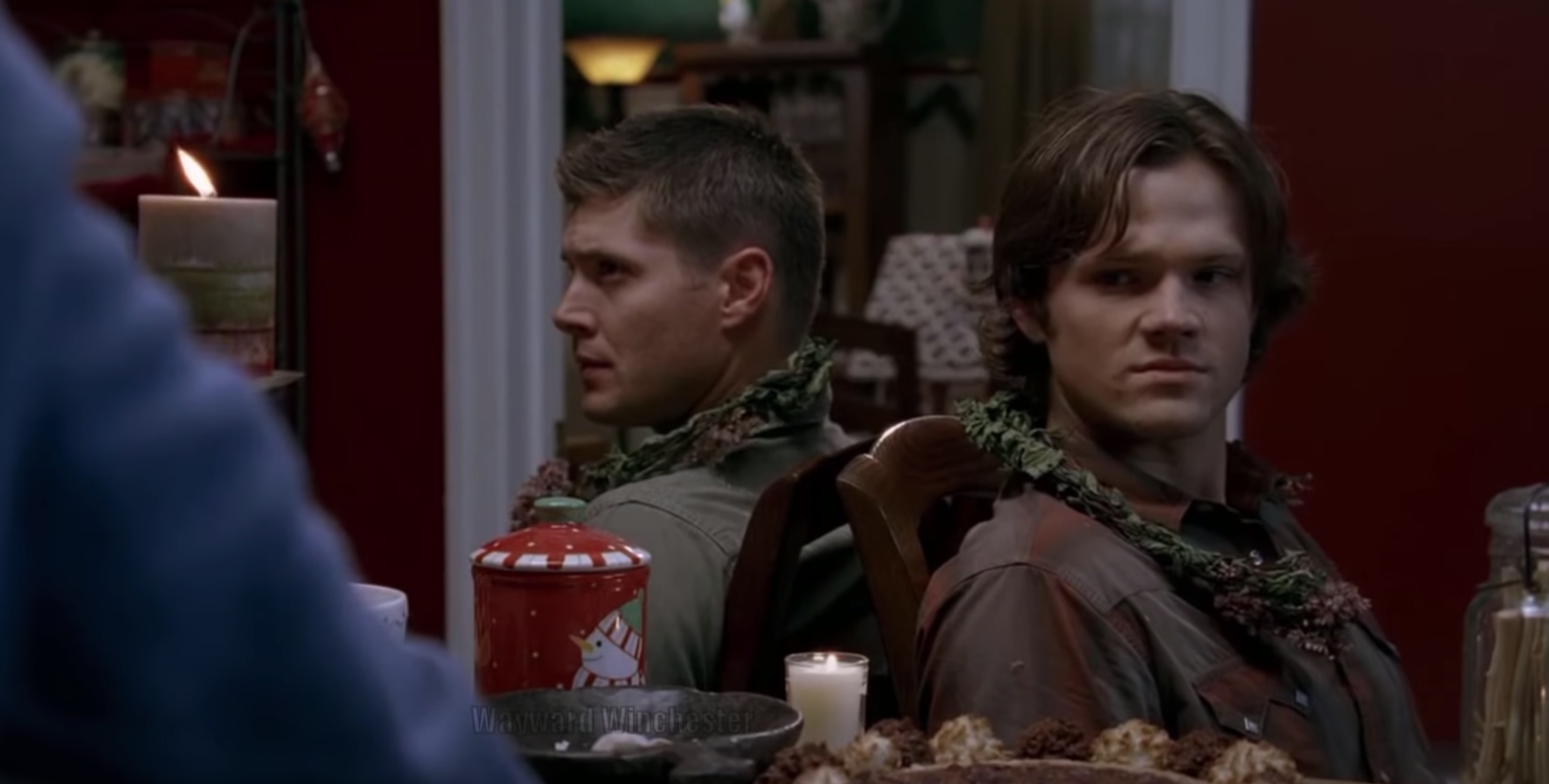Sam and Dean sit in a kitchen while they are tied up with garland on &quot;Supernatural.&quot;