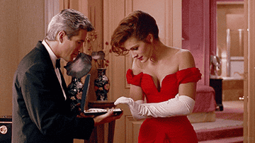 A GIF of the classic scene where Edward closes the necklace box on Vivian&#x27;s hand in &quot;Pretty Woman&quot;