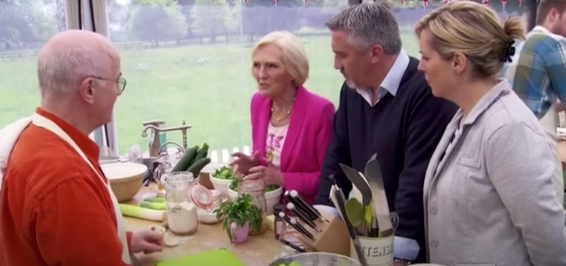 The judges discuss baked goods with one of the contestants on &quot;The Great British Bake Off.&quot;