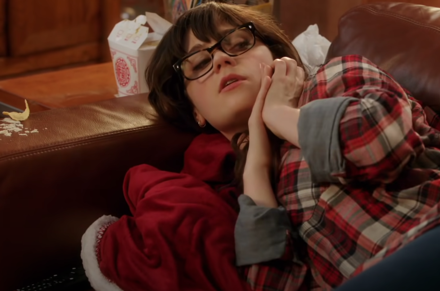 Jess is on the couch while on the phone with her mom in &quot;New Girl.&quot;