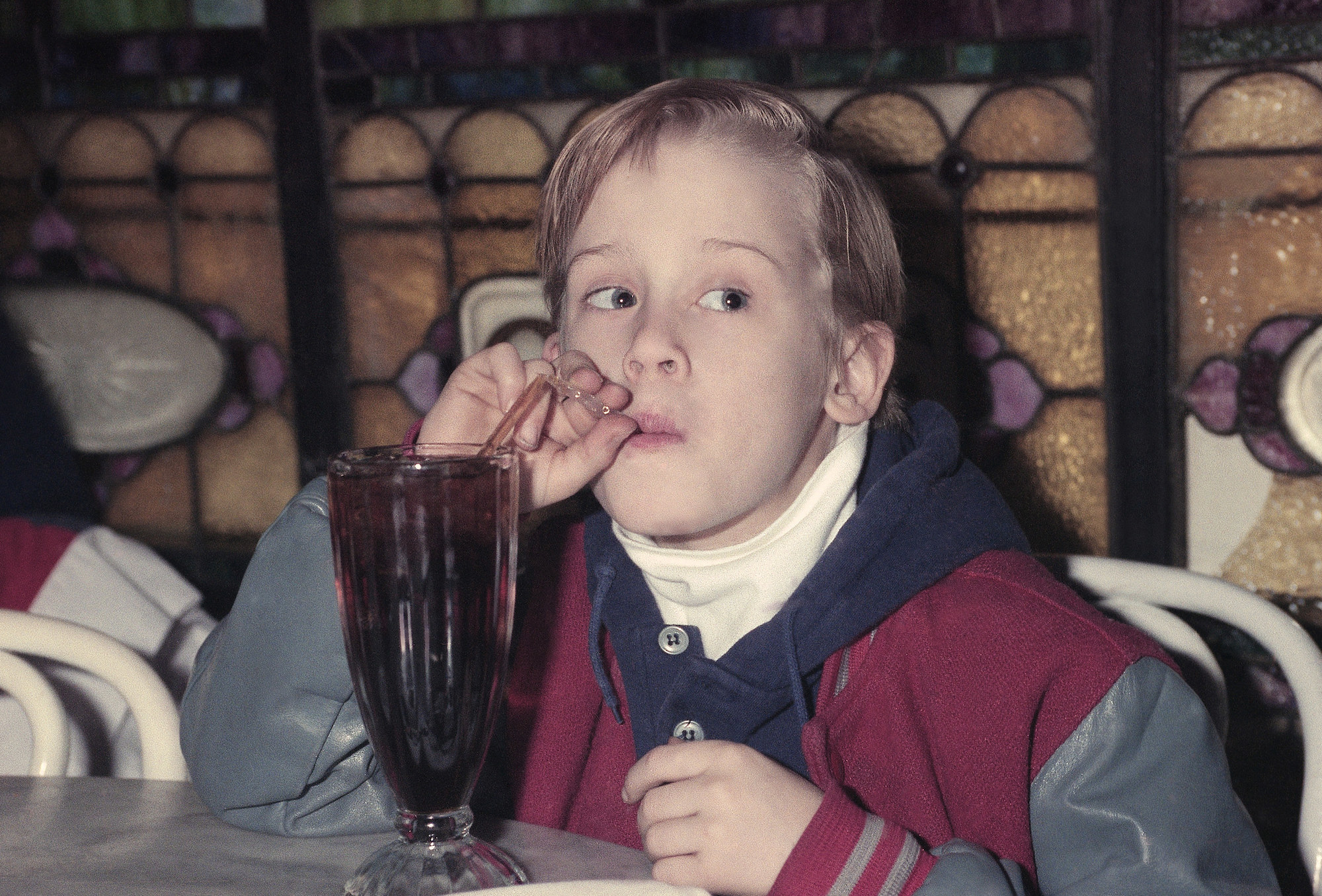 Macaulay drinking a soda as a kid