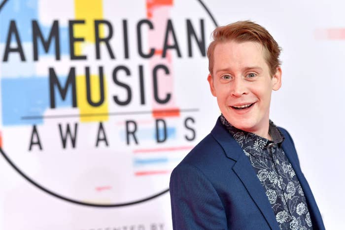 Macaulay Culking smiling on a red carpet