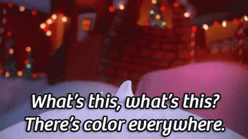 A GIF of Jack Skellington come out of some snow singing &quot;What&#x27;s this, what&#x27;s this? There&#x27;s color everywhere&quot;