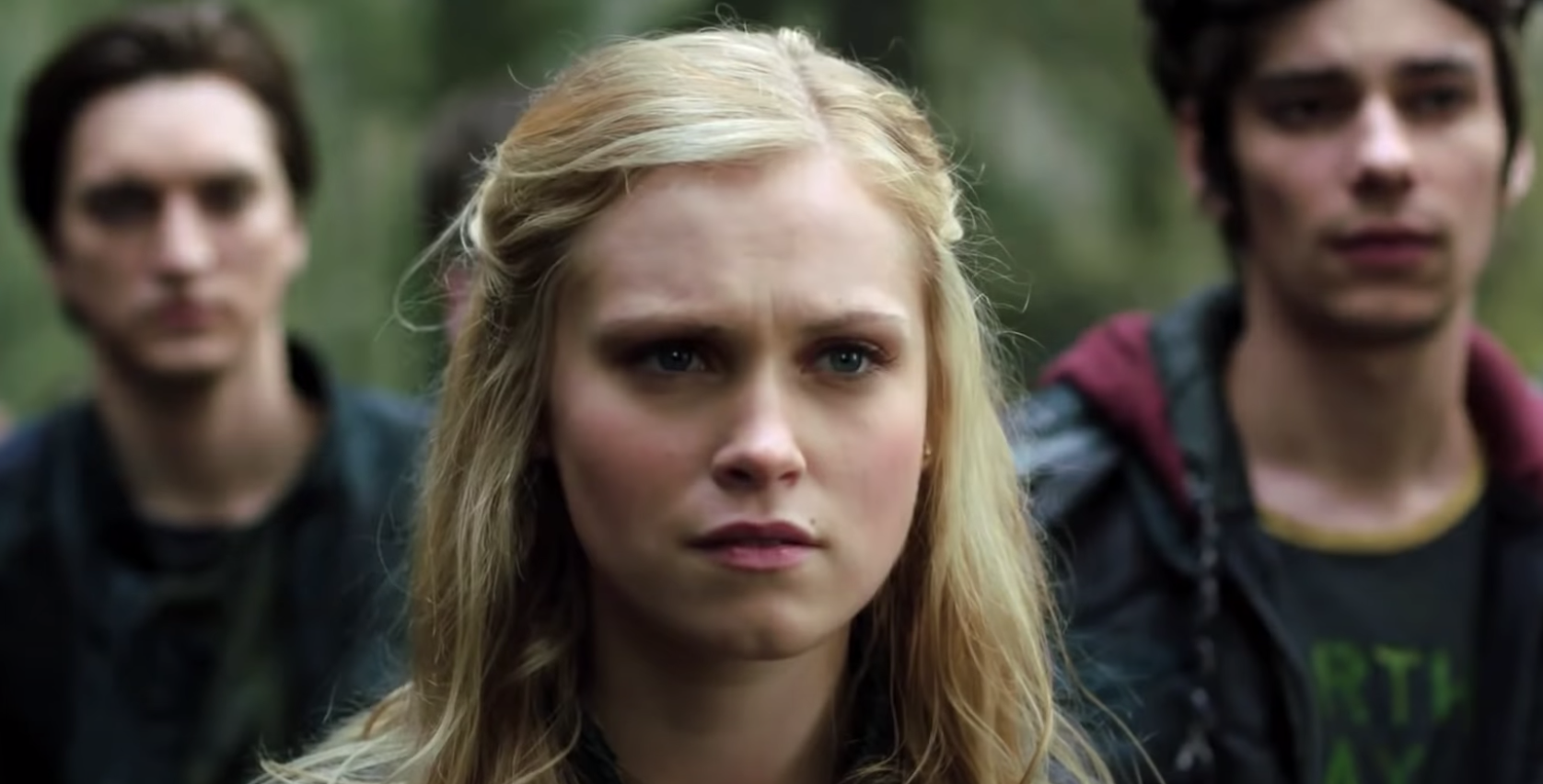 Murphy, Clarke, and Jasper stand on earth with concerned looks in &quot;The 100.&quot;