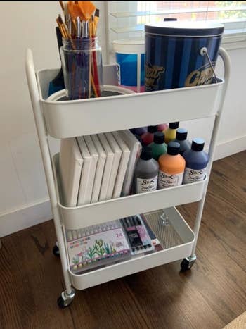 Reviewer pic of the storage cart with assorted art supplies in each tier