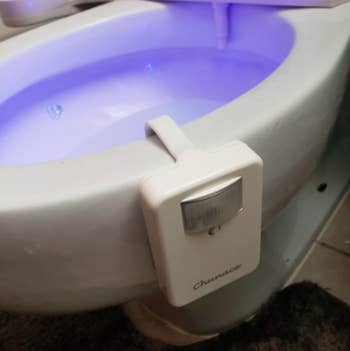 Closeup of the 16-Color Toilet Night Light, Motion Activated Detection Bathroom Bowl Lights attached to a customer's toilet