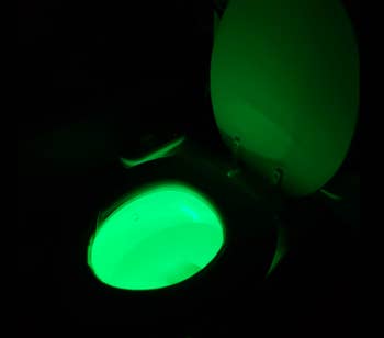 The same customer's toilet glowing green in the dark