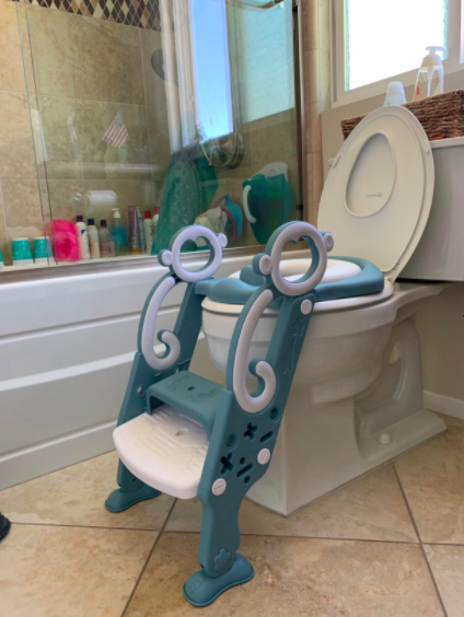 The DuDuEase Potty Training Toilet Seat with Step Stool Ladder in green and white in a customer&#x27;s bathroom