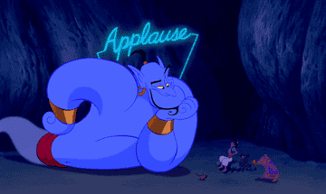 Genie, from Disney&#x27;s Aladdin, looking impressed with himself with the word &quot;Applause&quot; flashing above his head