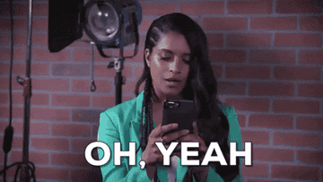 Lilly Singh looks at her phone and says oh yeah