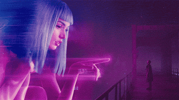 A large CGI girl looking down at Officer K in &quot;Blade Runner 2049&quot;