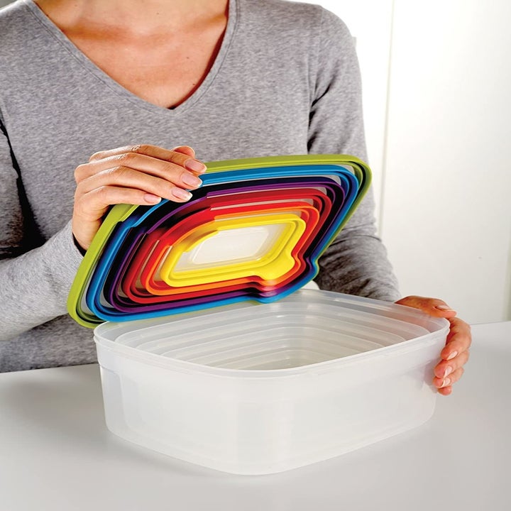 Model opening stack of multi-colored lids on food storage containers