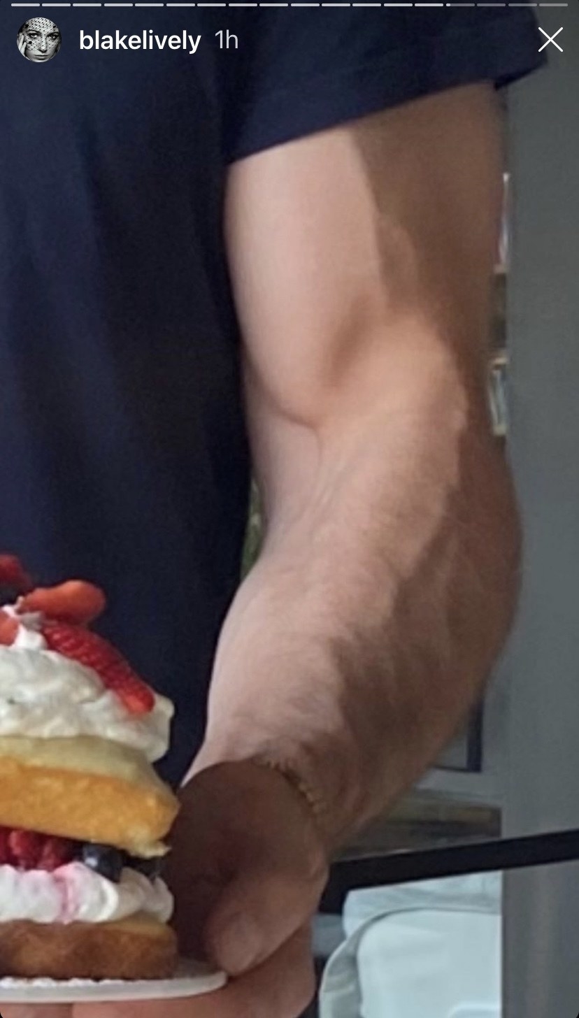 A zoomed-in version of the cake photo, zoomed in on Ryan&#x27;s muscular bicep holding the cake