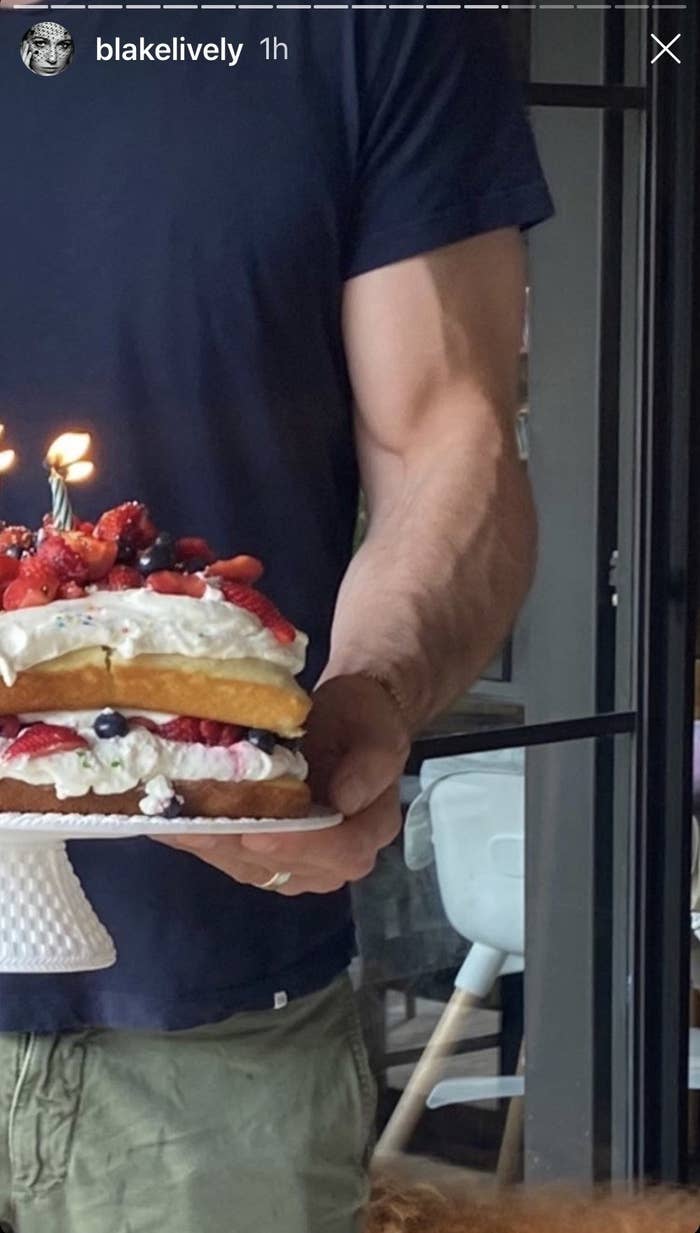 A zoomed-in version of the cake photo, zoomed in on Ryan&#x27;s muscular bicep holding the cake