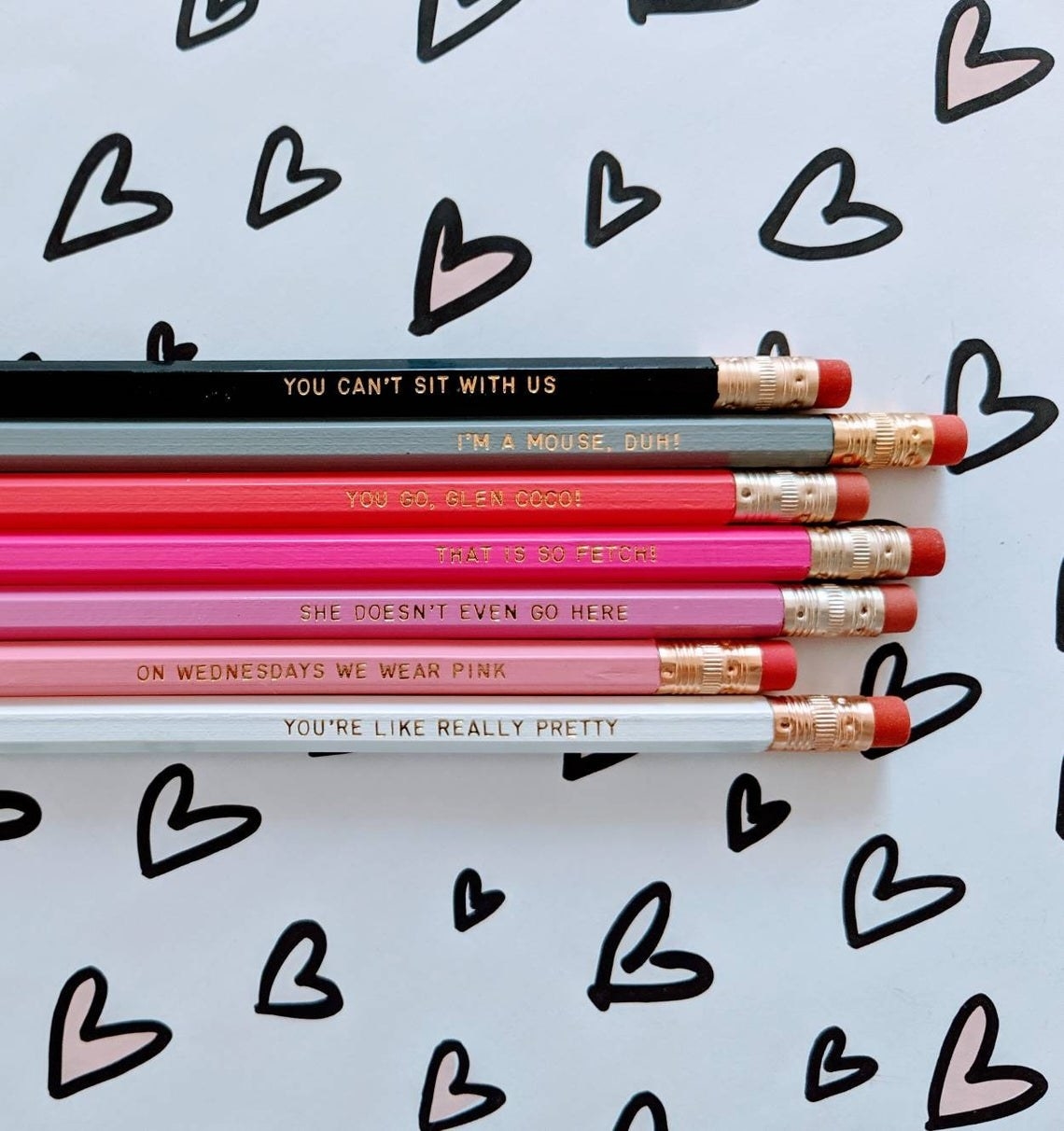 A set of seven pencils of different colours with Mean Girls quotes on each