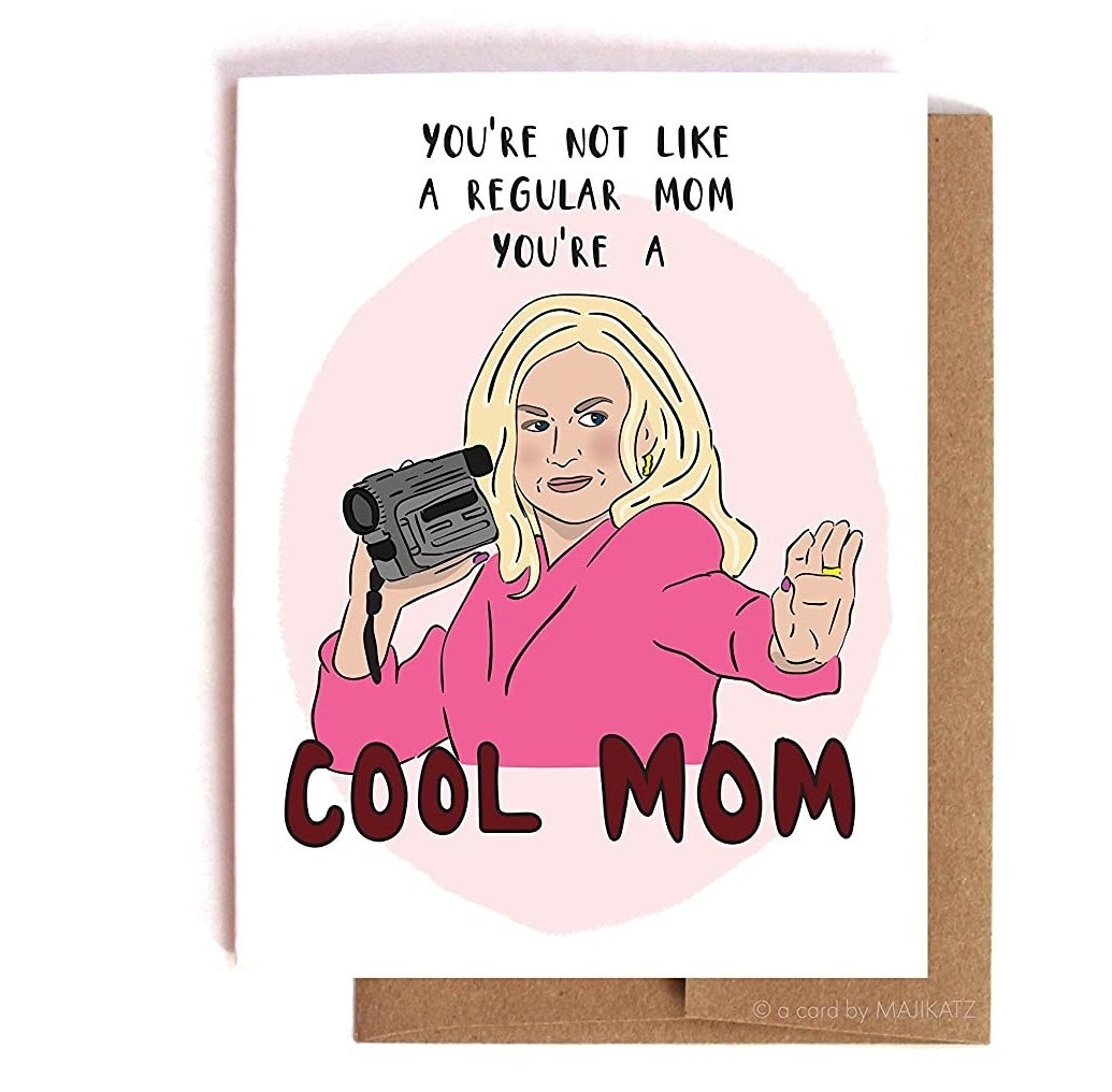 A greeting card with Mean Girls character Mrs. George holding a camcorder with a caption that says You're not like a regular mom you're a cool mom