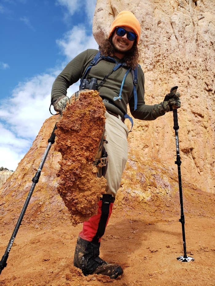 A reviewer using the two poles, which have small circular stands on the bottoms, in a dry climate
