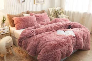 Plush, textured bedding set on a neatly made bed with pillows in a cozy, stylish bedroom featuring a chair, plant, and soft lighting